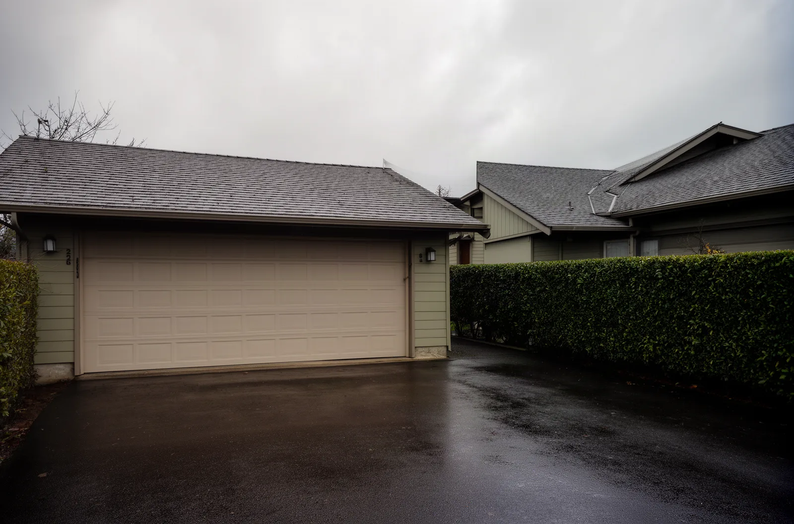 A closed two-car garage door on a suburban home