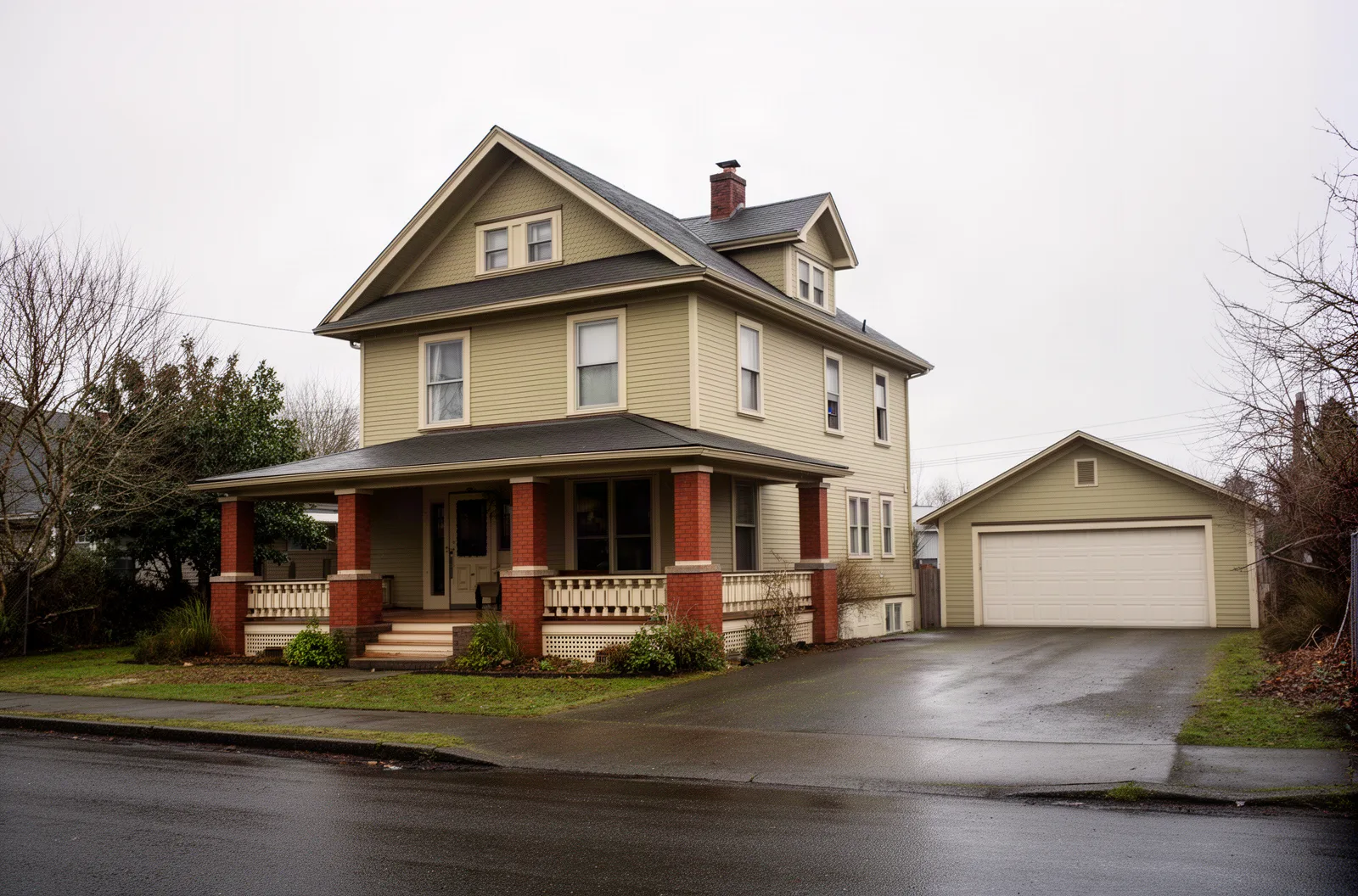 A foursquare house with a detached garage in Northeast Portland